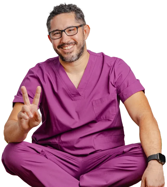 Dr. Oscar Mascareño sentado en pose de meditación, sonriendo y haciendo un gesto de calma